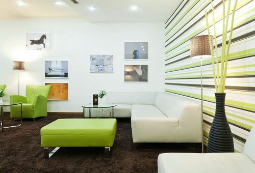 Moderne Hotel-Lobby mit Sofas, Sesseln und Bildern an der Wand.